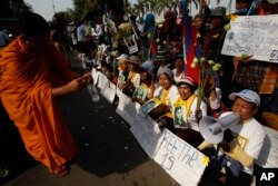Villagers from the Boeung Kak lake community shout slogans during a protest rally in front of Appeals Court in Phnom Penh, Cambodia, Jan. 22, 2015.