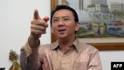 FILE - Jakarta Governor Basuki Tjahaja Purnama, shown speaking to reporters in August 2014, says preparations are under way to make the capital presentable for the Asia-Africa summit.