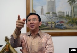 FILE - Then-Jakarta vice governor Basuki Tjahaja Purnama, known by his nickname Ahok, speaks to journalists at his office in Jakarta.