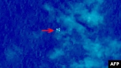 Handout photo provided by China Center for Resources Satellite Data and Application shows satellite image, illustrating objects in a "suspected crash sea area" in the South China Sea on March 9, 2014.