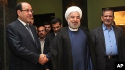 FILE - Iran's President Hassan Rouhani (c) shakes hands with Iraqi Prime Minister Nouri al-Maliki, in their meeting in Tehran, Iran.