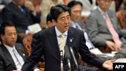 Japanese Prime Minister Shinzo Abe answers a question by an opposition lawmaker at the Upper House at the National Diet in Tokyo, April 23, 2013.