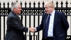 U.S. Secretary of State Rex Tillerson, left, is welcomed by Britain's Foreign Secretary Boris Johnson in London, Jan. 22, 2018.