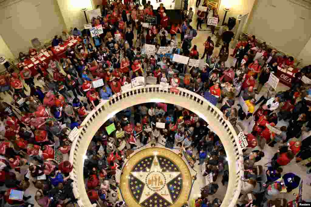 Teachers pack the state Capitol rotunda, on the second day of a teacher walkout, to demand higher pay and more funding for education, in Oklahoma City, Oklahoma.