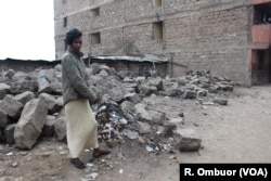 Mathare resident Sarah Wangari points to where her son lost his life. She said police gunned him down as he walked home with four friends on Nov. 18 of last year.