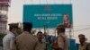 An Indian Police officer briefs his colleagues at the entrance of HITECH city, venue of the Global Entrepreneurship Summit in Hyderabad, India, Nov. 27, 2017. 