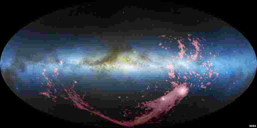 A long ribbon of gas called the the Magellanic Stream (in pink), stretches nearly halfway around our Milky Way galaxy (in blue). New Hubble observations reveal most of the gas was stripped from the Small Magellanic Cloud about 2 billion years ago, and a second region of the stream originated more recently from the Large Magellanic Cloud.