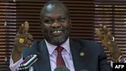 FILE - South Sudan's rebel leader Riek Machar gestures as he holds a press conference.