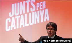 FILE - Former President Carles Puigdemont speaks during a launch of the electoral campaign of his platform Together for Catalonia for the Catalan regional elections at Oostkamp in Belgium, Nov. 25, 2017.