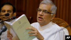 Sri Lanka's sacked prime minister Ranil Wickremesinghe holds a copy of the constitution of Sri Lanka as he attends a media briefing at his official residence in Colombo, Sri Lanka, Oct. 29, 2018.