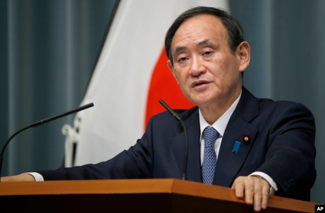 FILE - Japan's Chief Cabinet Secretary Yoshihide Suga speaks to the media during a press conference at the prime minister's official residence in Tokyo.