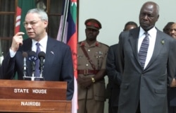 FILE - U.S. Secretary of State Colin Powell, left, gestures as he answers a question from the press as Kenyan President Daniel arap Moi looks on, in Nairobi, May 26, 2001.