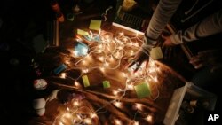 A girl touches a sensory toy in an altar of comforting objects during a meeting for the "Sisters in Strength" in the Brooklyn borough of New York on March 6, 2019.