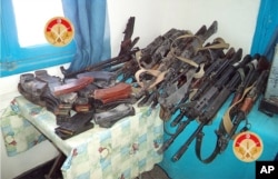 FILE - This photo taken Monday, Match 7, 2016 and provided by the Tunisian Defense Minister on Tuesday, March 8, 2016 shows weapons seized by Tunisian forces from militants in the city of Ben Guerdane, southern Tunisia. (Tunisian Defense Ministry via AP)