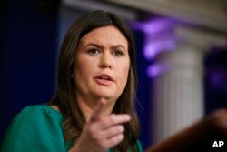 White House press secretary Sarah Huckabee Sanders talks to reporters during a press briefing in the Brady press briefing room at the White House in Washington, Oct. 29, 2018.