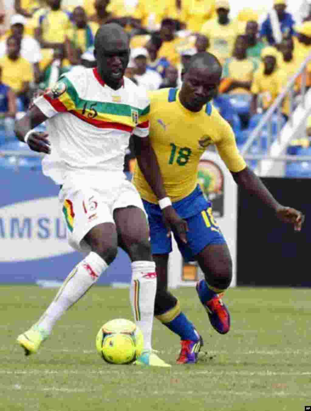 Mali's Bakaye Traore (L) fights for the ball with Gabon's Cedric Moubamba during their African Cup of Nations quarter-final soccer match at the Stade De L'Amitie Stadium in Gabon's capital Libreville, February 5, 2012.