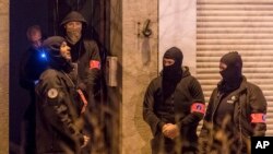 Police search an area in the Schaerbeek neighborhood in Brussels, Dec. 19, 2016. 