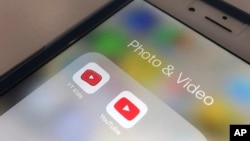 In this file photo, the YouTube app and YouTube Kids app are displayed on a smartphone in New York. A new survey confirms what a lot of parents already know: Teens and tweens are consuming a lot of online video. (AP Photo/Jenny Kane, File)