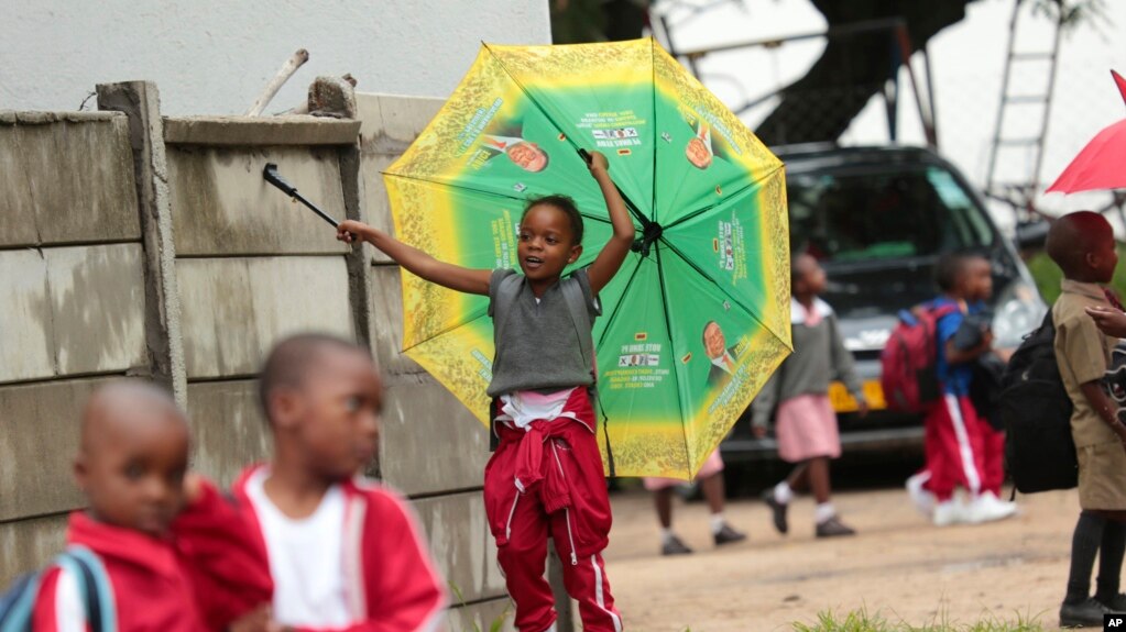 A child plays with an umbrella bearing the portrait of Zimbabwean President Emmerson Mnangagwa, at a public school in Harare, Feb. 5, 2019. Public teachers are alleging intimidation as they try to launch a nationwide strike for better salaries.