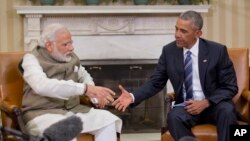 President Barack Obama reaches to shake hands with Indian Prime Minister Narendra Modi during their meeting in the Oval Office of the White House in Washington, June 7, 2016.