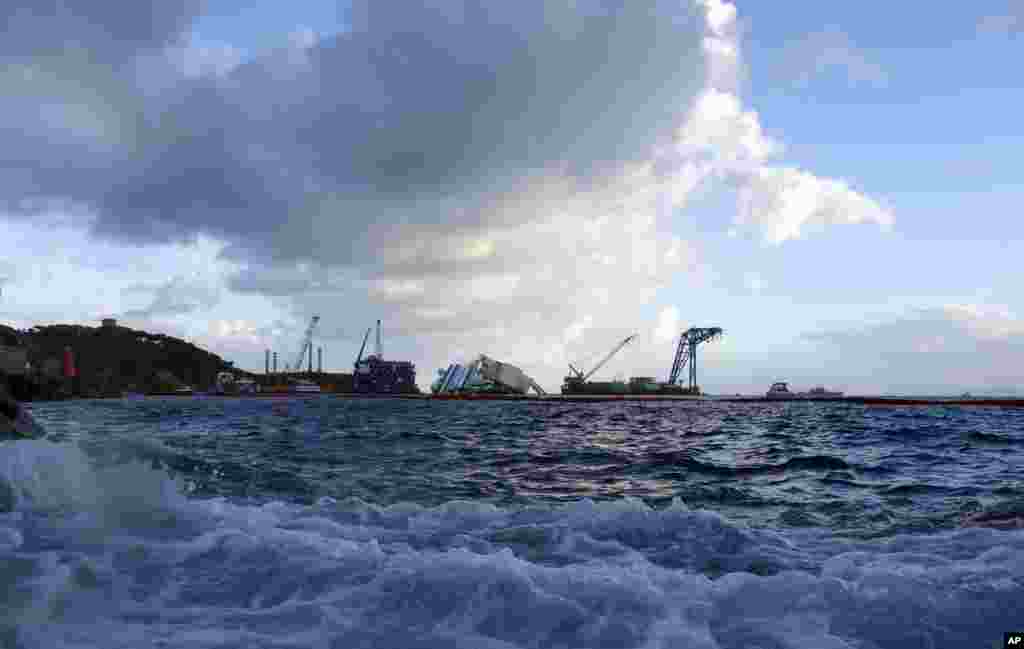 The Costa Concordia ship lies on its side near the Tuscan Island of Giglio, Italy, Sept. 16, 2013.