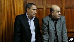 Iranian nationals Sayed Mansour Mousavi, left, and Ahmed Abolfathi Mohammed, right stand in the Nairobi magistrates court in Nairobi, Kenya, (File photo).