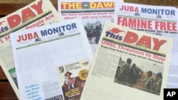 This photo taken June 22, 2017 shows South Sudanese newspaper front pages, including two with news stories removed by the printer on the instructions of the government in Juba.