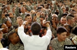 FILE - President Barack Obama greets troops in Kentucky in 2011, thanking those who recently returned from Afghanistan.