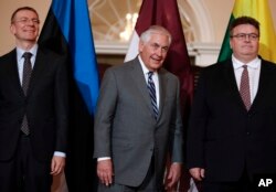 FILE - From left, Latvian Foreign Minister Edgars Rinkevics, U.S. Secretary of State Rex Tillerson and Lithuanian Foreign Minister Linas Antanas Linkevicius appear during a media opportunity at the State Department in Washington, March 5, 2016.