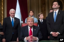 President Donald Trump is joined by the Congressional leadership and his family before formally signing his cabinet nominations into law, Jan. 20, 2107, in the President's Room of the Senate on Capitol Hill in Washington.