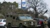 An armored law enforcement vehicle is seen in the area where a man has reportedly taken people hostage at a synagogue during services that were being streamed live, in Colleyville, Texas, Jan. 15, 2022. 
