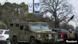 An armored law enforcement vehicle is seen in the area where a man has reportedly taken people hostage at a synagogue during services that were being streamed live, in Colleyville, Texas, Jan. 15, 2022. 