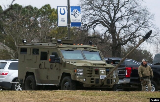 An armored law enforcement vehicle is seen in the area where a man has reportedly taken people hostage at a synagogue during services that were being streamed live, in Colleyville, Texas, Jan. 15, 2022.