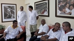 Cuban doctors, who will travel to Liberia and Guinea, wait for the start of a press event in Havana, Oct. 21, 2014. 
