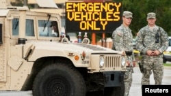 Missouri National Guard soldiers stand by at a police command post in Ferguson, Missouri, Aug. 19, 2014.