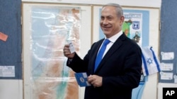 Israeli Prime Minister Benjamin Netanyahu casts his ballot at a polling station in Jerusalem, January 22, 2013.