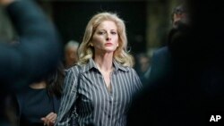 FILE- Summer Zervos leaves Manhattan Supreme Court at the conclusion of a hearing in New York, Dec. 5, 2017.