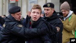 FILE - Belarus police arrest journalist Raman Pratasevich in Minsk, Belarus, March 26, 2017. 