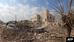 Destruction is seen around the Udai hospital following airstrikes on the town of Saraqeb in Syria's northwestern province of Idlib, Jan. 29, 2018. 