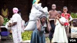 A widow works as a porter at a market in Goma, Democratic Republic of the Congo. (VOA/Nick Long) 