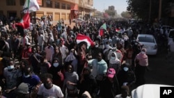People march during a protest to denounce the October military coup, in Khartoum, Sudan, Thursday, Dec. 30, 2021. 