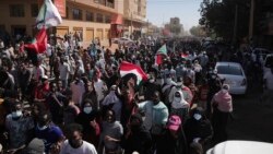 People march during a protest to denounce the October military coup, in Khartoum, Sudan, Dec. 30, 2021.