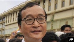 Cambodian opposition party leader Sam Rainsy, stands in front of the municipal court in Phnom Penh, Cambodia. 