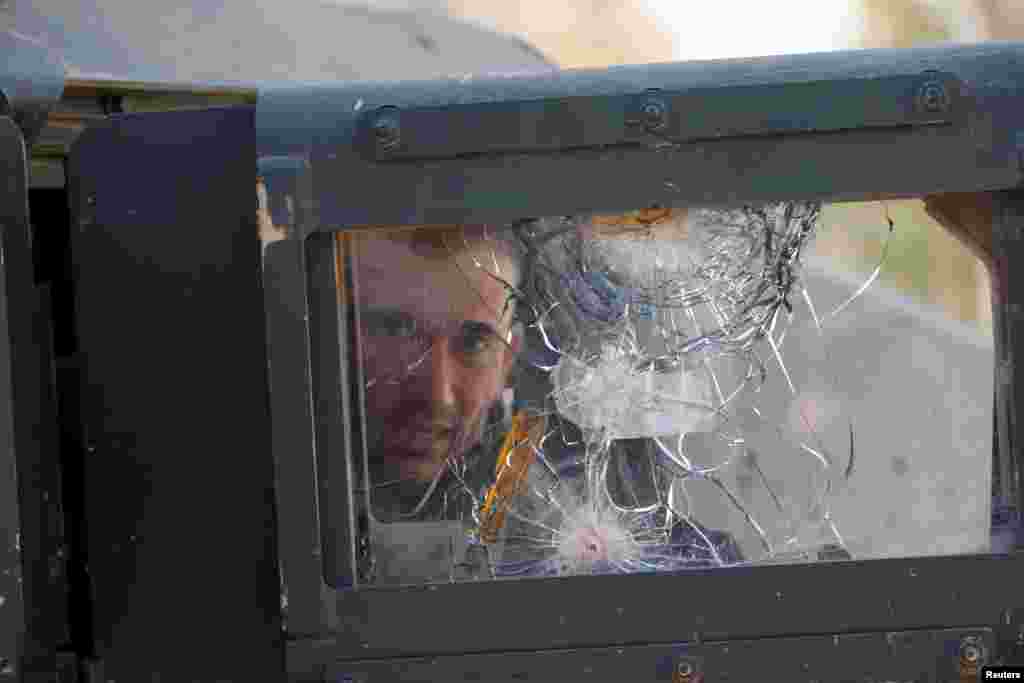 A member of the Iraqi rapid response forces sits in a military vehicle during battle with Islamic State militants in the Mithaq district of eastern Mosul.