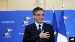 Francois Fillon puts his hand on his heart after delivering a speech following the conservative presidential primary, in Paris, France, Nov. 27, 2016. An ex-prime minister, Fillon roundly defeated Alain Juppe, another former head of government.