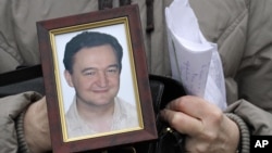 This Nov. 30, 2009 photo shows a portrait of Sergei Magnitsky, a Russian lawyer who worked to expose corruption and died in a Russian prison.