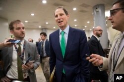 Sen. Ron Wyden, D-Ore., the ranking member of the Senate Finance Committee, arrives for votes at the Capitol in Washington, Oct. 19, 2017.