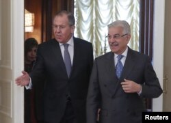 FILE - Russian Foreign Minister Sergei Lavrov (L) shows the way to his Pakistani counterpart Khawaja Asif during a meeting in Moscow, Feb. 20, 2018.