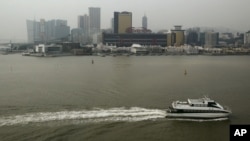 FILE - A ferry sails across the Casino Sands' Macau, Dec.19, 2009. 