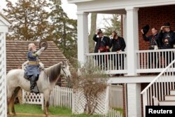 Period-costumed actor of General Robert E. Lee leaves after the surrender during the 150th anniversary re-enactment of the surrender of General Robert E. Lee to General Ulysses S. Grant at the Court House National Historic Park in Appomattox, Virginia, April 9, 2015.